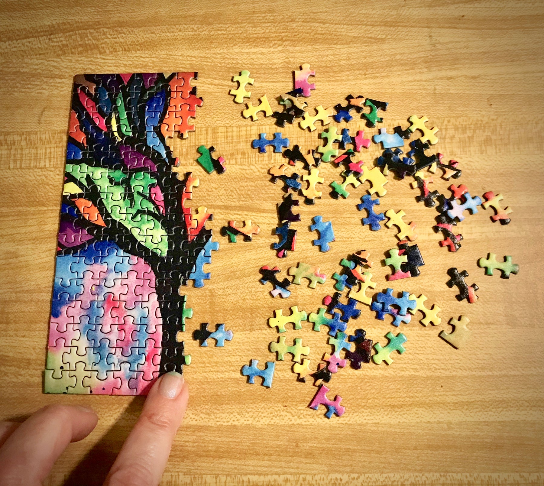 MicroPuzzle mini jigsaw puzzle being built from left to right colorful stained glass tree design